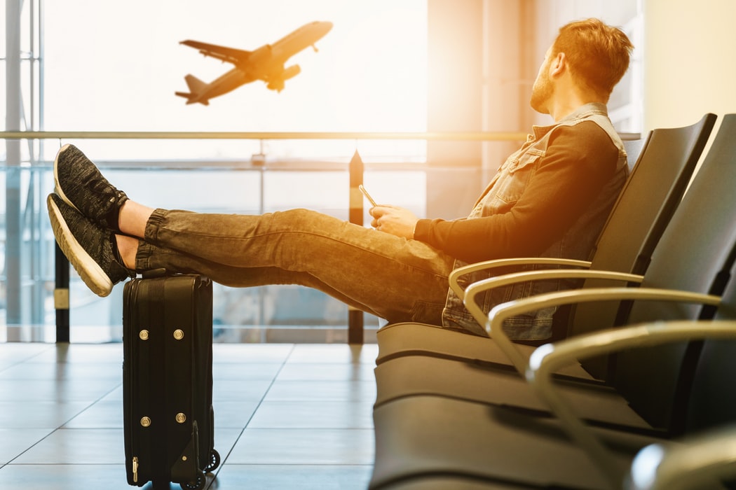 lgbt traveller sitting in airport